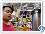 Grad student Linh Le next to the Main Cryostat which goes down to 50 Millikelvin. Le's research focuses on superconducting quantum interference devices (Boyd)