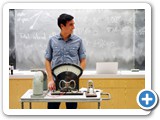 Zach Castillo watches Montie Avery while preparing to demonstrate Faraday's law (A magnetic field will interact with an electric circuit to produce an electromotive force).