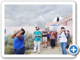 Mesmerized by a natural event, students and visitors peer at the sun through eclipse-viewing glasses. The UNM campus observatory was open 