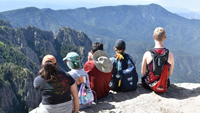 REU 2018 program participants
      	                   sitting on the edge at the top of Sandia Mountain