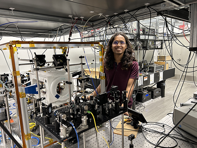 Grad student Sudhan Bhadade working on the cold-atom experimental platform in the Quantum Optics laboratory at UNM