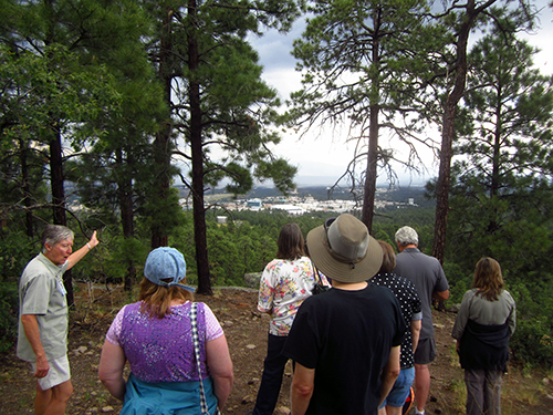 Overlooking LANL, teachers listen to the guide's description of some main laboratory features