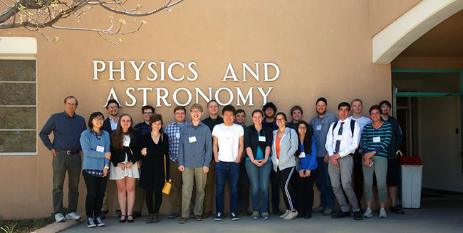 Physics faculty and student participants group photo in front of the Physics building at 1919 Lomas NE