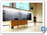 Alex Doerfler explains her research with a slideshow presentation