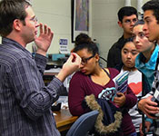 Research Assistant Professor Alexander Albrecht explains surface physics to visiting high school students